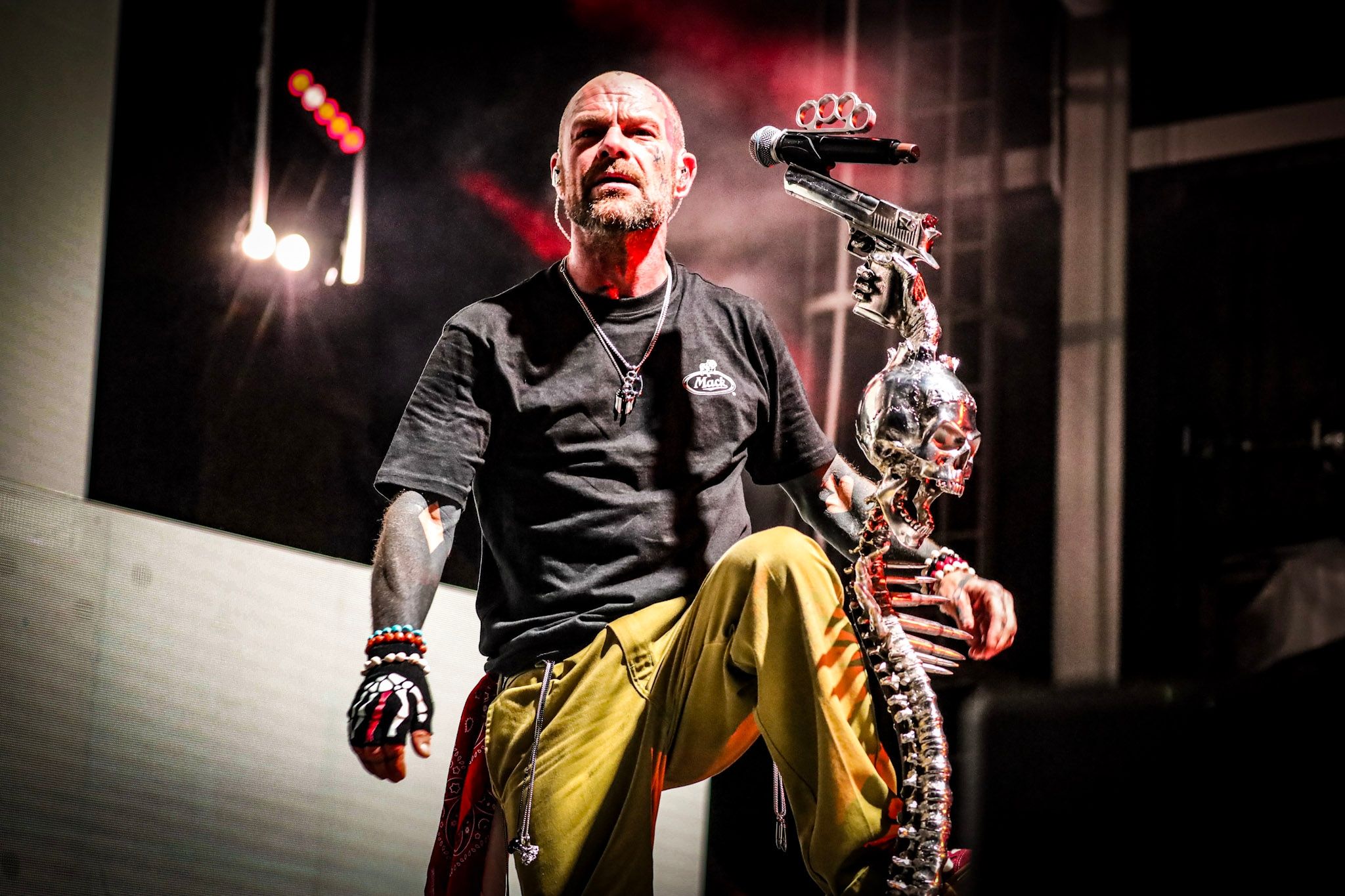 Five Finger Death Punch's singer on stage under red light